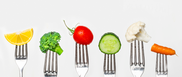 Fruit and vegetable of silver forks against a white background concept for healthy eating, dieting and antioxidant