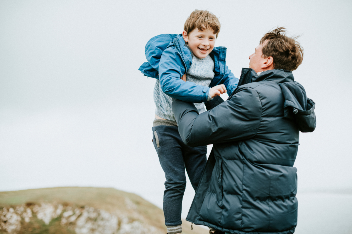 Assessment a child being carried by a male happily