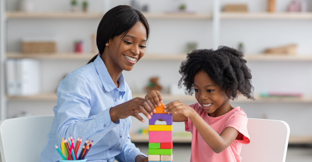 woman and child playing with tower blocks