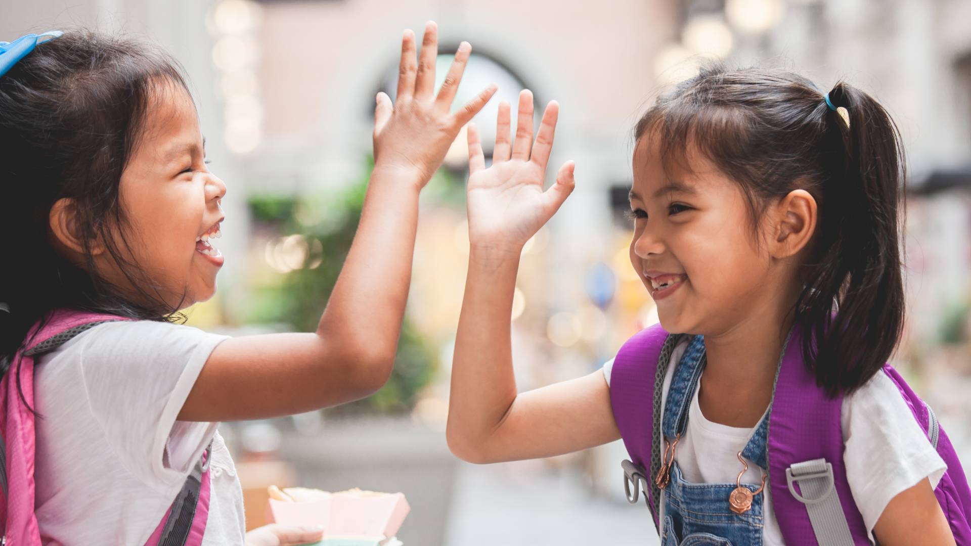 children high fiving and smiling