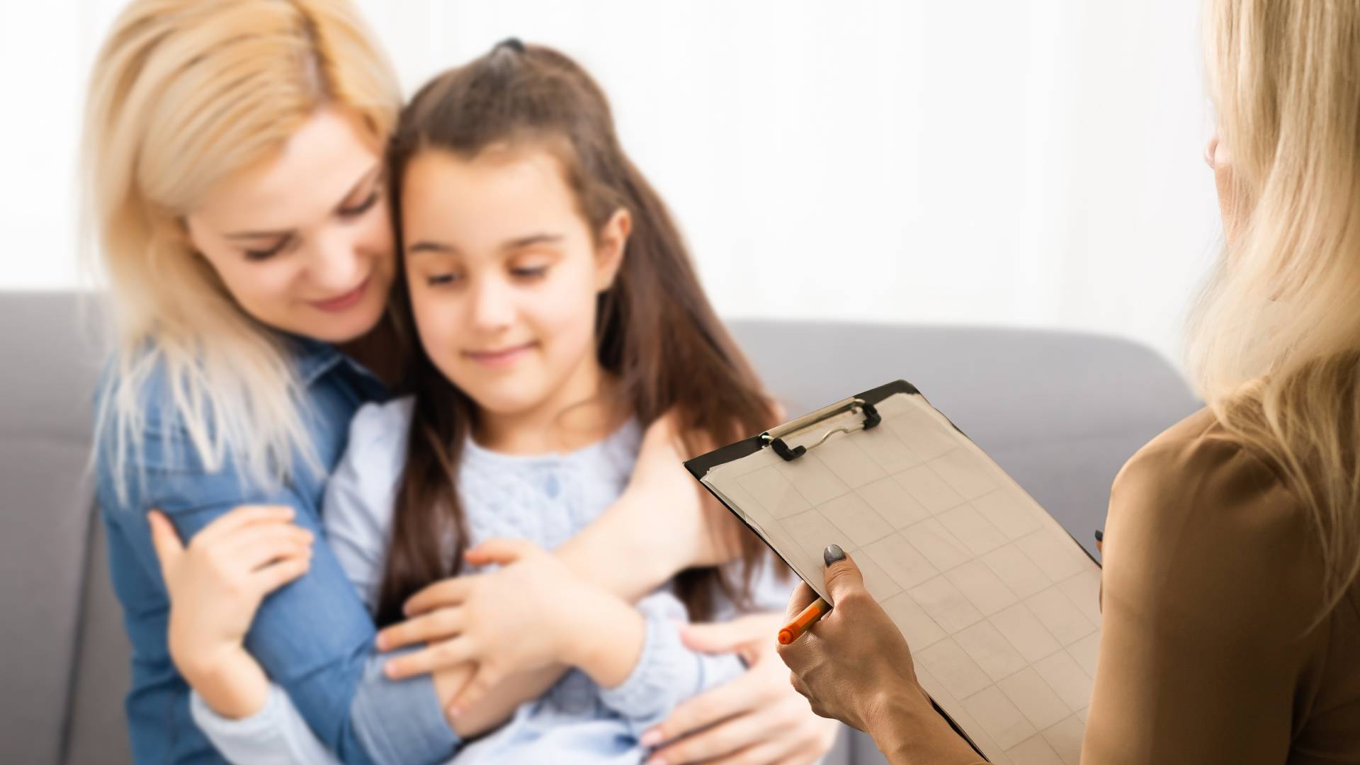 Children Talking Therapy a woman holding a child talking to a therapist
