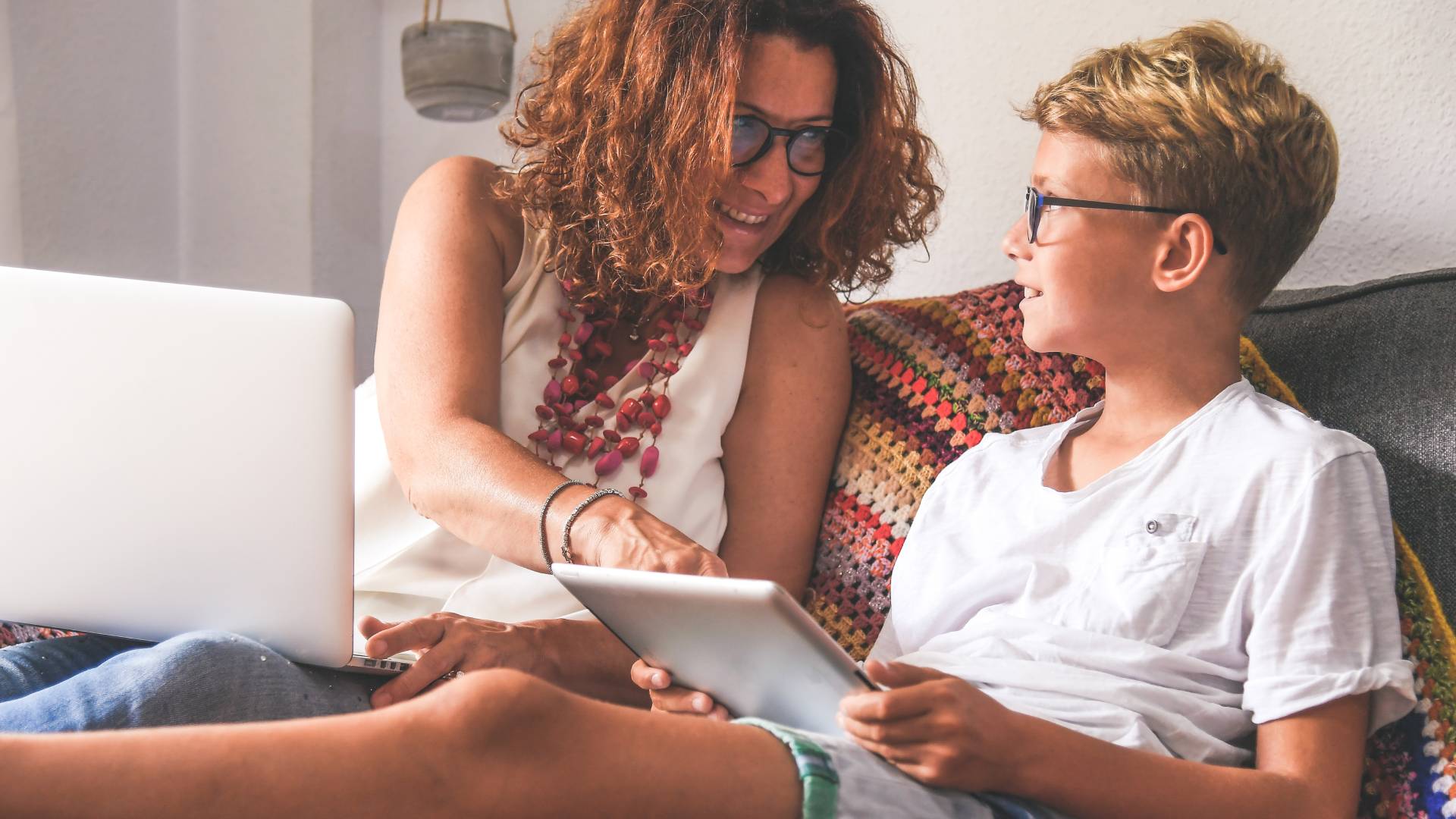 Effective, evidence-based treatments a woman helping a child with their tablet