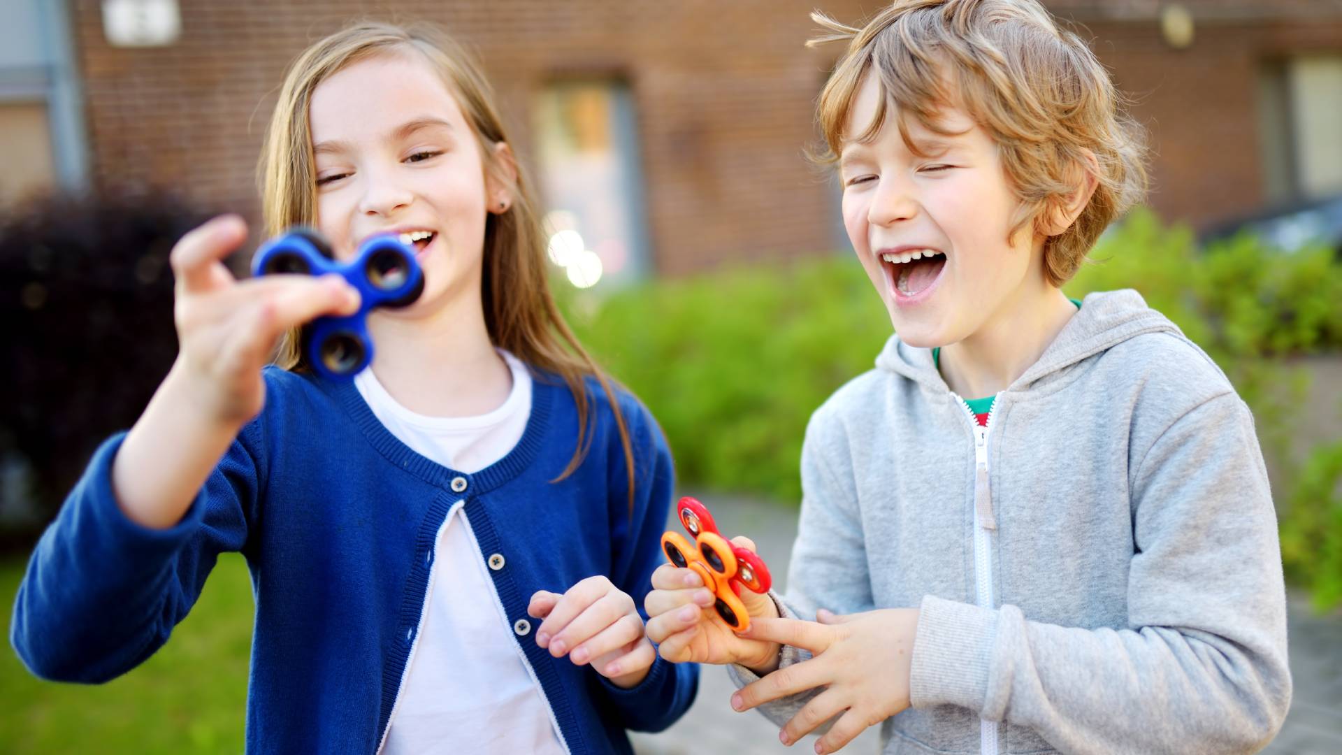 Subtypes of autism (1) two children playing with fidget spinners