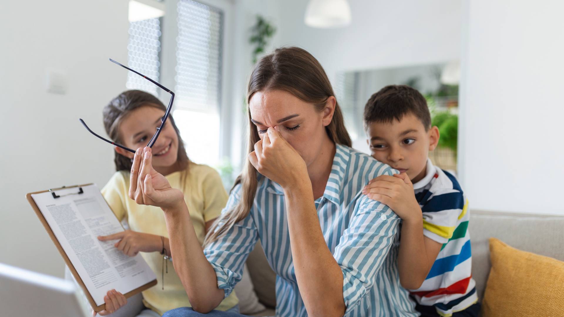 Types of ADHD an overwhelmed woman with two children behind her trying to talk to her and get her attention