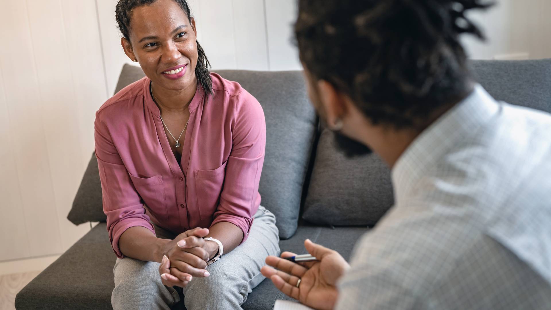 What is CBT_ a woman talking to a therapist or a professional while sitting on a sofa