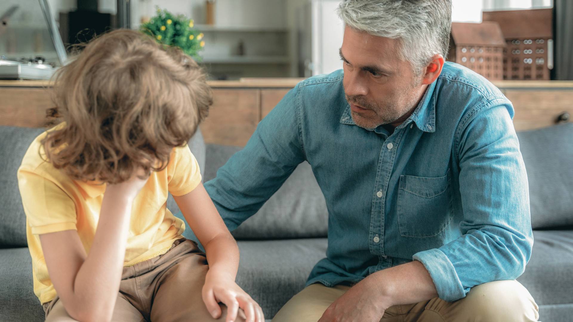 a man and a child talking seriously